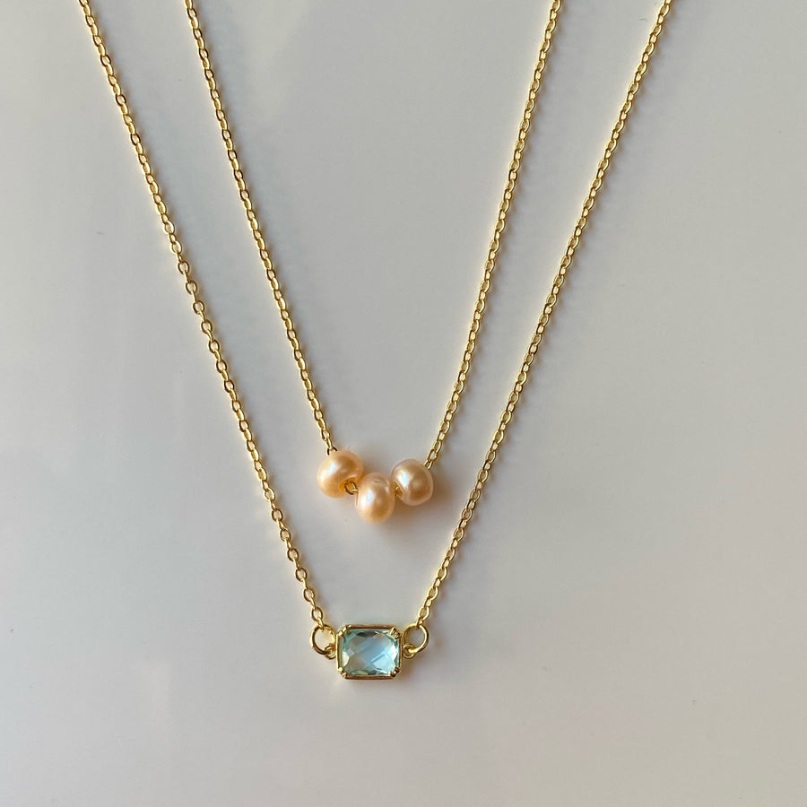    Layered pearl and crystal pendant necklace